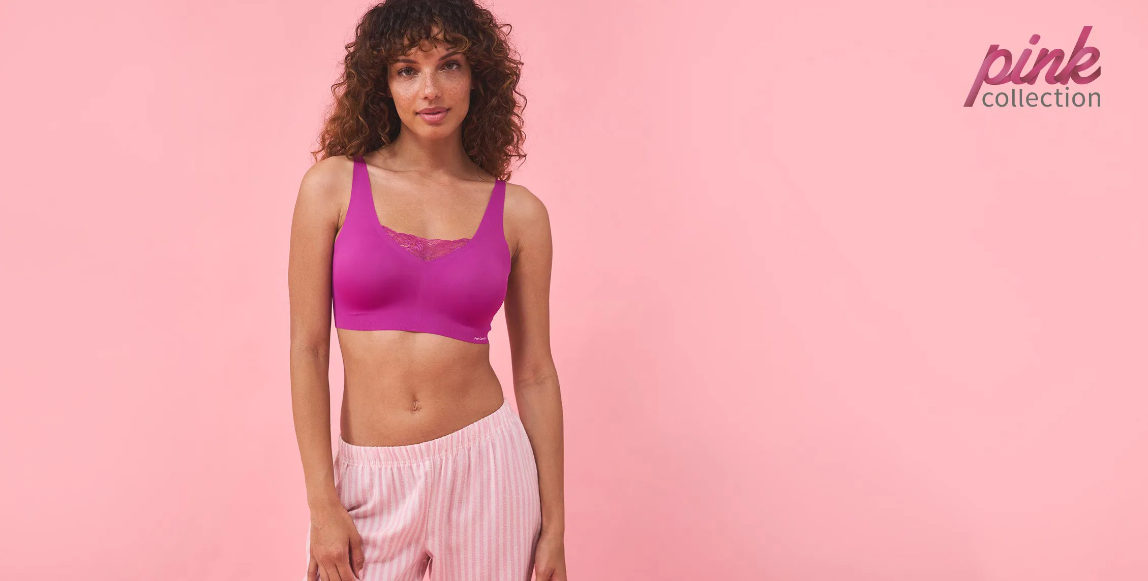 Sportieve outfit: lila croptop en gestreepte roze broek. Perfect voor fitness en vrije tijd.