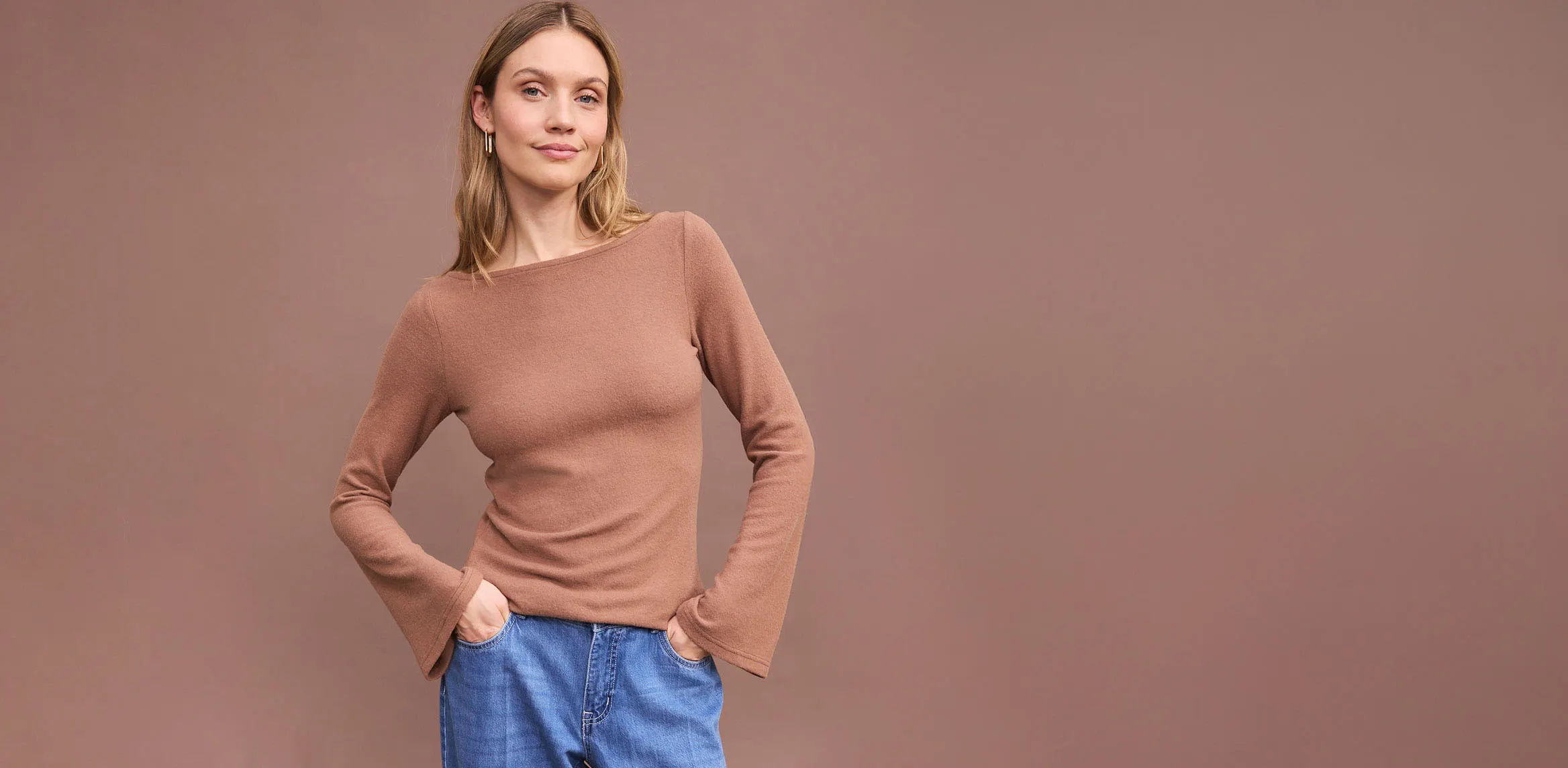 Bruine top met lange mouwen en comfortabele blauwe jeans.